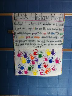 a bulletin board with handprints on it in a bathroom stall that says black history month