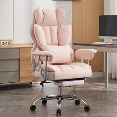 a pink office chair sitting on top of a hard wood floor next to a computer desk