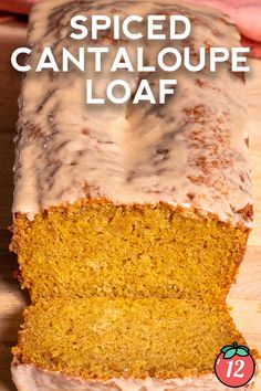 a loaf of cake sitting on top of a wooden cutting board with frosting over it