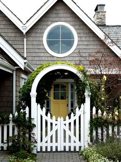 a house with a yellow door and white picket fence