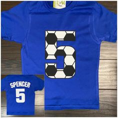 a blue shirt with the number five printed on it and a matching t - shirt