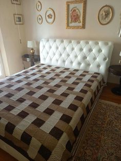 a bed with a brown and white checkered bedspread