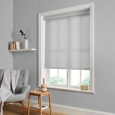 a living room with grey walls and white blinds