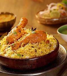 a wooden bowl filled with food on top of a table