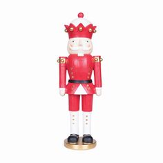 a red and white nutcracker figurine with gold accents