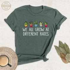 We All Grow At Different Rates Shirt, Kindergarten Teacher Tshirt, Teacher Gift Outfit, Teacher Appreciation Tee, Elementary Teacher Tshirt. Welcome to BestMomentTees! Step into a world of comfort and style with our handmade shirts from the renowned Bella Canvas brand. The solid colors are 100% pure cotton, while the delightful heather colors are a charming blend of 52% cotton and 48% polyester. 🍃 Each shirt is a true labor of love, meticulously created using the innovative DTF printing method. Green Graphic Tee With Funny Text, Plant Teacher Shirt, Funny Green T-shirt With Slogan, Teacher In Progress Shirt, Cheap Retro T-shirt For Teacher Appreciation, Fun Teacher Appreciation T-shirt With Graphic Print, Short Sleeve T-shirt With Name Print For Teacher Appreciation, Handmade Shirts, Kindergarten Teachers