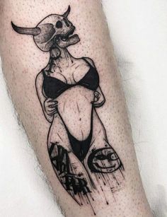 a black and white photo of a person with a bull tattoo on their leg,