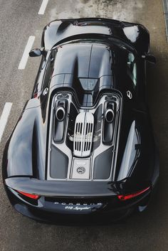 a black sports car is parked on the street