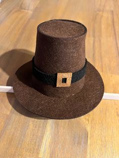 a brown hat sitting on top of a wooden floor