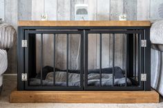 a dog bed in front of a wooden wall with metal bars on the top and bottom