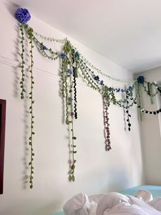 there are many flowers hanging on the wall in this room, and one is blue