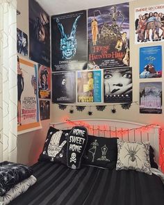 a bedroom with posters on the wall above the bed