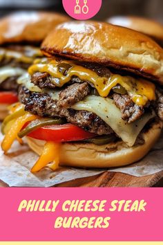 two cheese steak burgers sitting on top of a wooden cutting board with text overlay that reads, philly cheese steak burgers