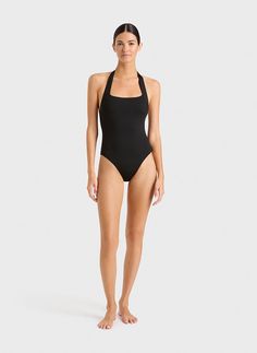 The Candice one piece in black is an elegant, feminine halterneck swimsuit that will never go out of style. The suit also works perfectly as a bodysuit worn under trousers or a skirt. A comfortable, wide, elasticated strap runs from under the shoulders and behind the neck. A scoop back reveals the shoulders. Self-lined in our ultra-soft Embodee™ fabric with high shaping power, Candice will become your go-to suit every summer. Luxury fabric sustainably made in Italy. Chic Stretch Bodysuit For Pool, Chic Stretch Bodysuit For The Pool, Chic High Stretch Swimming Bodysuit, Chic Stretch Swimwear With Lined Body, Chic High Stretch Bodysuit For Swimming, Sleek One-piece Stretch Swimwear, Chic High Stretch Swimwear With Built-in Bra, Sleek Stretch One-piece Swimwear, Sleek Elastane Swimwear For Summer