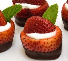 chocolate covered strawberries with whipped cream and mint leaves