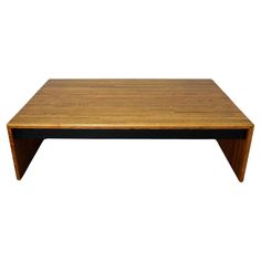 a wooden coffee table with black legs and a square top on an isolated white background