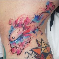 a woman's stomach with an image of a fish and flowers on the side