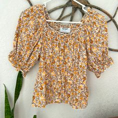 Old Navy Nwot!!! Women's Short Sleeve Boho Floral Top Size Xs!! This Shirt Has An Elastic Back Down To The Waist And Blouses From There Down, Elastic Around Sleeves W Faux Bow And An Elastic Band Around Waist In Front. Print Is Peach, Orange And Cream W A Bit Of Blue. Really Pretty! Orange Short Sleeve Tops For Spring, Fitted Orange Floral Print Tops, Orange Tops For Fall Day Out, Orange Cotton Tops For Spring, Orange Relaxed Fit Tops, Trendy Orange Top For Day Out, Casual Mustard Tops With Floral Print, Casual Mustard Top With Floral Print, Spring Orange Tops With Floral Print