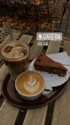 there is a piece of cake on the plate next to a cup of cappuccino