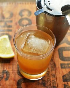 a drink with ice and lemon on a table