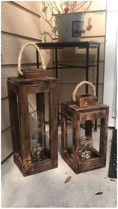 two wooden lanterns sitting on top of a porch