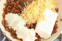 a skillet filled with meat, cheese and sour cream