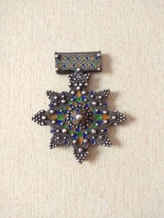 Beautiful traditional silver berber cross pendant, with nice quality enamel work, most likely handmade in Morocco (Tiznit) . This extremely well made vintage piece that tests silver. The enamel colors used are vivid and contrast wonderfully with the granulation work. Length : 9,2 cm (3,6 inches) Width : 7,6 cm (2,9 inches) Height : 1 cm (0,4 inches) Weight : 58 g Traditional Cross Jewelry For Collectors, Traditional Collectible Cross Jewelry, Old Silver Coins, Enamel Cross, Moroccan Jewelry, Enamel Jewelry, Coin Pendant, Silver Coins, Photo Jewelry