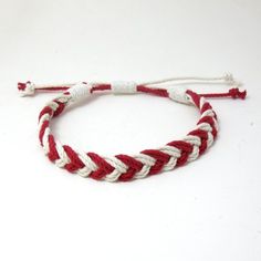 Red and White Chevron Braid Cotton Sailor AnkletThis anklet is fully adjustable and should fit most ankles, opening up to about 13 inches and is about 1/2 inch wide. Made out of braided cotton cord with the ends whipped in a narrower cotton cord.This represents three generations of craftsmanship on the coast of Connecticut creating the finest sailor bracelet on the market today. Enjoy what over 50 years of continual refinement can create using custom American made cord. Handmade Red Braided Bracelet For Beach, Casual Red Friendship Bracelets With Adjustable Cord, Casual Red Braided Bracelets For Beach, Casual Red Braided Bracelet For Beach, Traditional Red Woven Braided Bracelets, Chevron Fashion, Red Heart-shaped Braided Bracelets For Gifts, Hand-strung Red Braided Friendship Bracelets, Handmade Red Heart-shaped Braided Bracelets