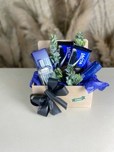 a gift box filled with personal care items on top of a white table next to a cat