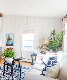 a living room filled with furniture and a fire place next to a wall mounted tv