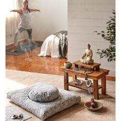 a woman is doing yoga in the living room