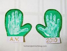 two handprints with green and gold paint on them