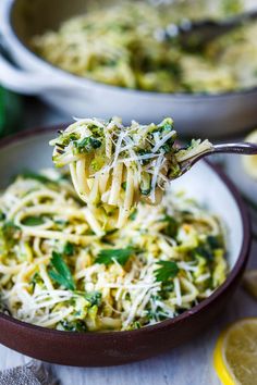 a spoon full of pasta with broccoli and parmesan cheese