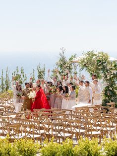 a group of people standing next to each other on top of a wooden chair covered field