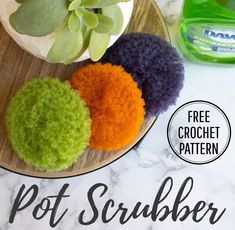 three crochet pot scrubbers sitting on a plate with succulents