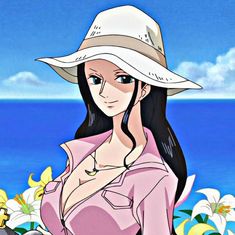 a woman wearing a white hat standing in front of the ocean with flowers around her