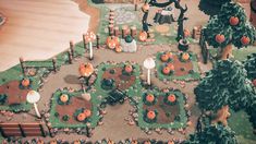 an aerial view of a park with lots of trees and pumpkins on the ground