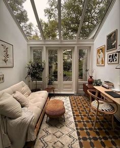 a living room filled with furniture and lots of windows on top of each other's sides