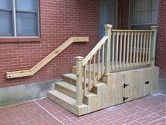 a wooden staircase next to a brick building