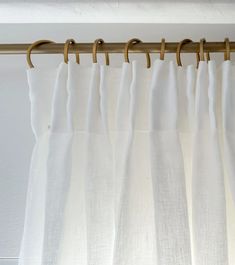 white curtains hanging on a wooden rod