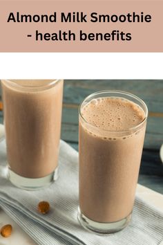 two glasses filled with almond milk on top of a table