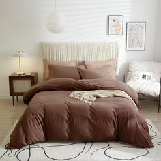 a bed with brown sheets and pillows in a bedroom