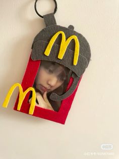 a woman in a mcdonald's hat hanging on a wall