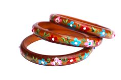 "A rich brown bangle that will add fun floral personality to your outfits featuring a row of hand-painted flowers in vibrant colors and delicate green leaves! In the center of every pink flower, a rhinestone adds the tiniest bit of sparkle! Choose a single bangle or buy a set of two or three to stack them and make a statement!  Wood Bangle, Inner Diameter 2 1/2\", 3/8\" wide                         SPECIAL SHIPPING RATES!!                         FREE US SHIPPING(certain items excluded) Single Bangle, Painting Candle Holders, Boho Elephant, Skull Pendant Necklace, Whimsical Jewelry, Hand Painted Jewelry, Painted Flower, Skull Pendant, Hand Painted Flowers