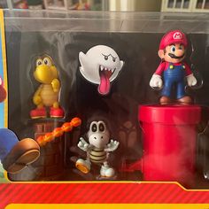 an assortment of action figures are displayed in a display case, including mario kart and other characters