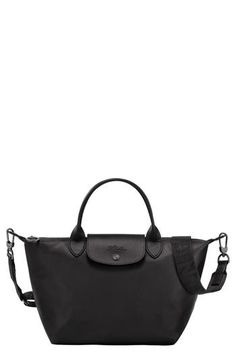 This scaled-down leather version of Longchamp's Le Pliage boasts the same foldaway design that made the bag a worldwide cult favorite. Top carry handles and a removable crossbody strap add to its ingenious versatility. Magnetic-snap flap with top zip closure Top carry handles; removable, adjustable crossbody strap Two interior wall pockets Structured silhouette with flat base for stability Logo-jacquard lining Leather Imported Longchamp Small Le Pliage, Longchamp Leather, Longchamp Bag, Summer Wardrobe Essentials, Wedding Guest Shoes, Sneaker Slippers, Woman Bags Handbags, Baby Boy Shoes, Boy Shoes