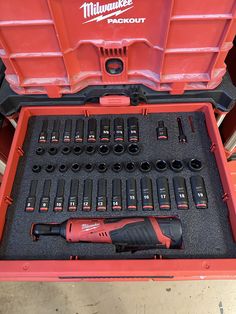 a red tool box filled with drill and screwdrivers