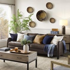 a living room filled with lots of furniture and decor on top of a carpeted floor