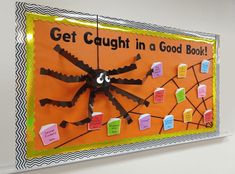 a bulletin board with sticky notes attached to it that says get caught in a good book