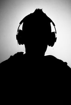 the silhouette of a man wearing headphones